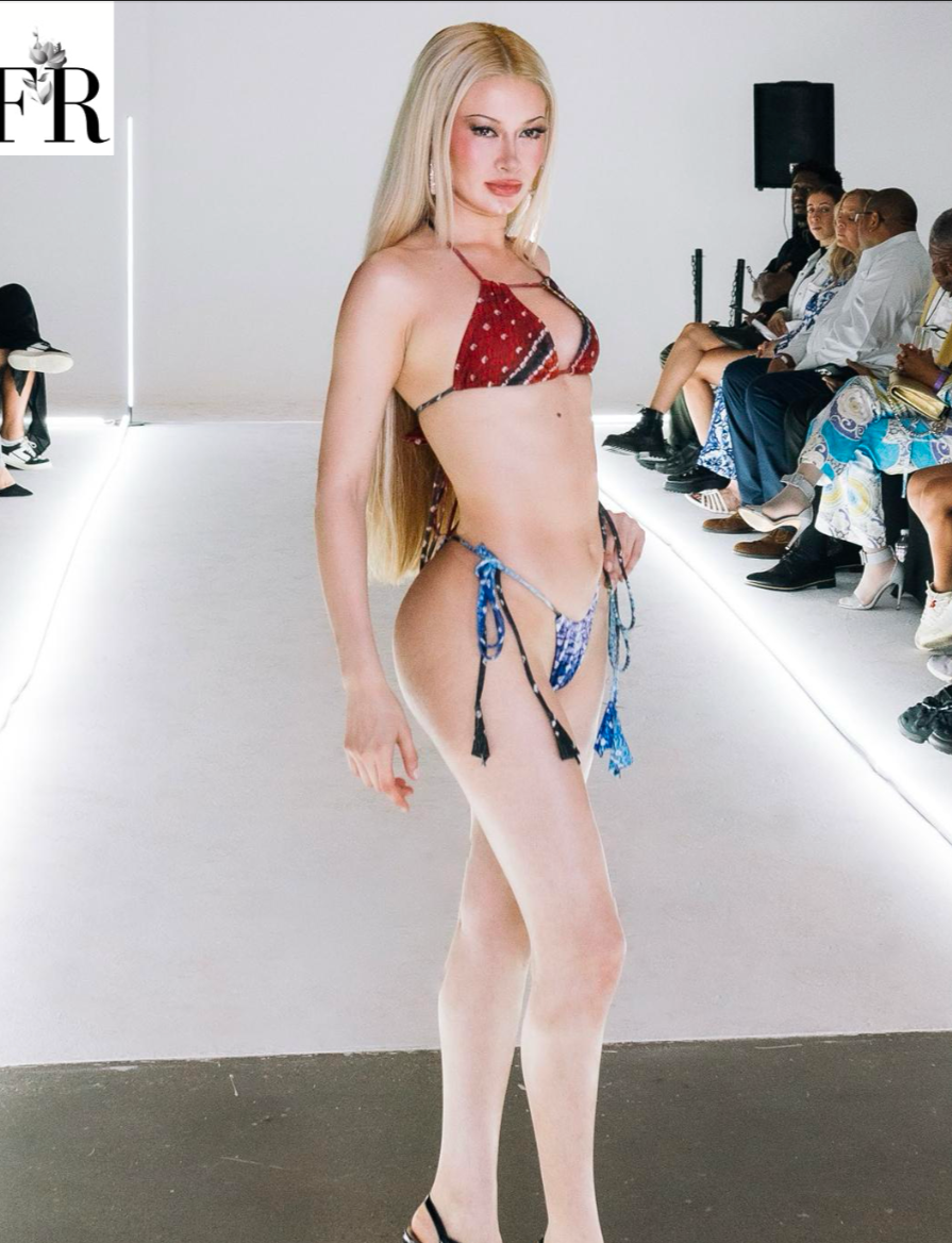 Side view of a mid-waist bikini bottom featuring red, black, and aqua color blocks with adjustable tie sides